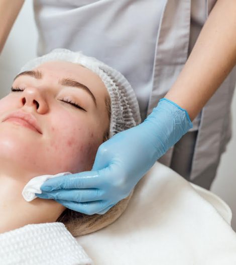 beautician-cleanse-moisturize-face-young-female beautician-cleanse-moisturize-face-young-female